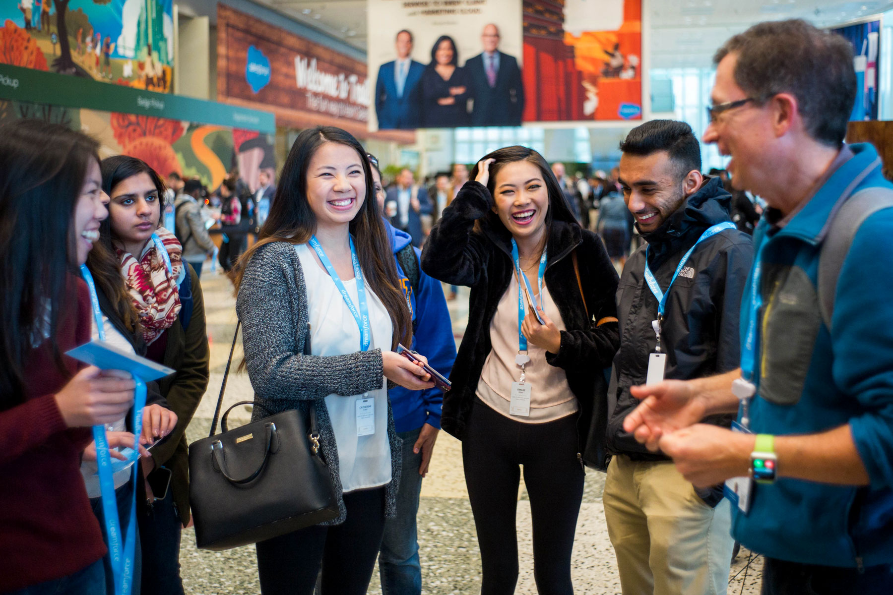 Students laughing while chatting at a Salesforce conference.