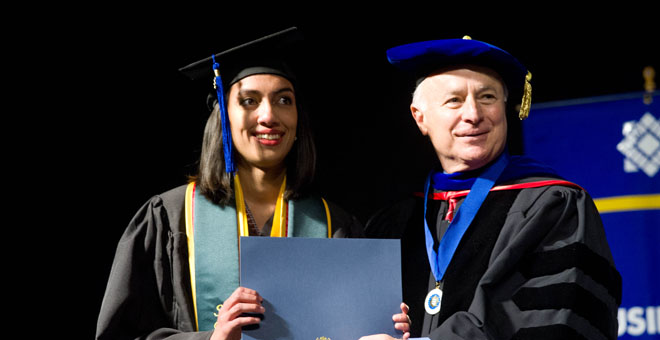 Sbona student gets congratulated by Dean Steele.