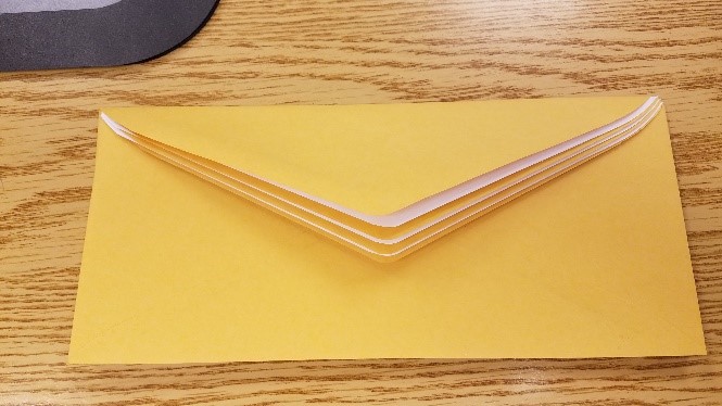Envelopes interleaved so flaps stack on top of each other