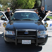 Police Officers by Patrol Car