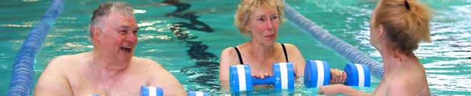 members smiling in pool