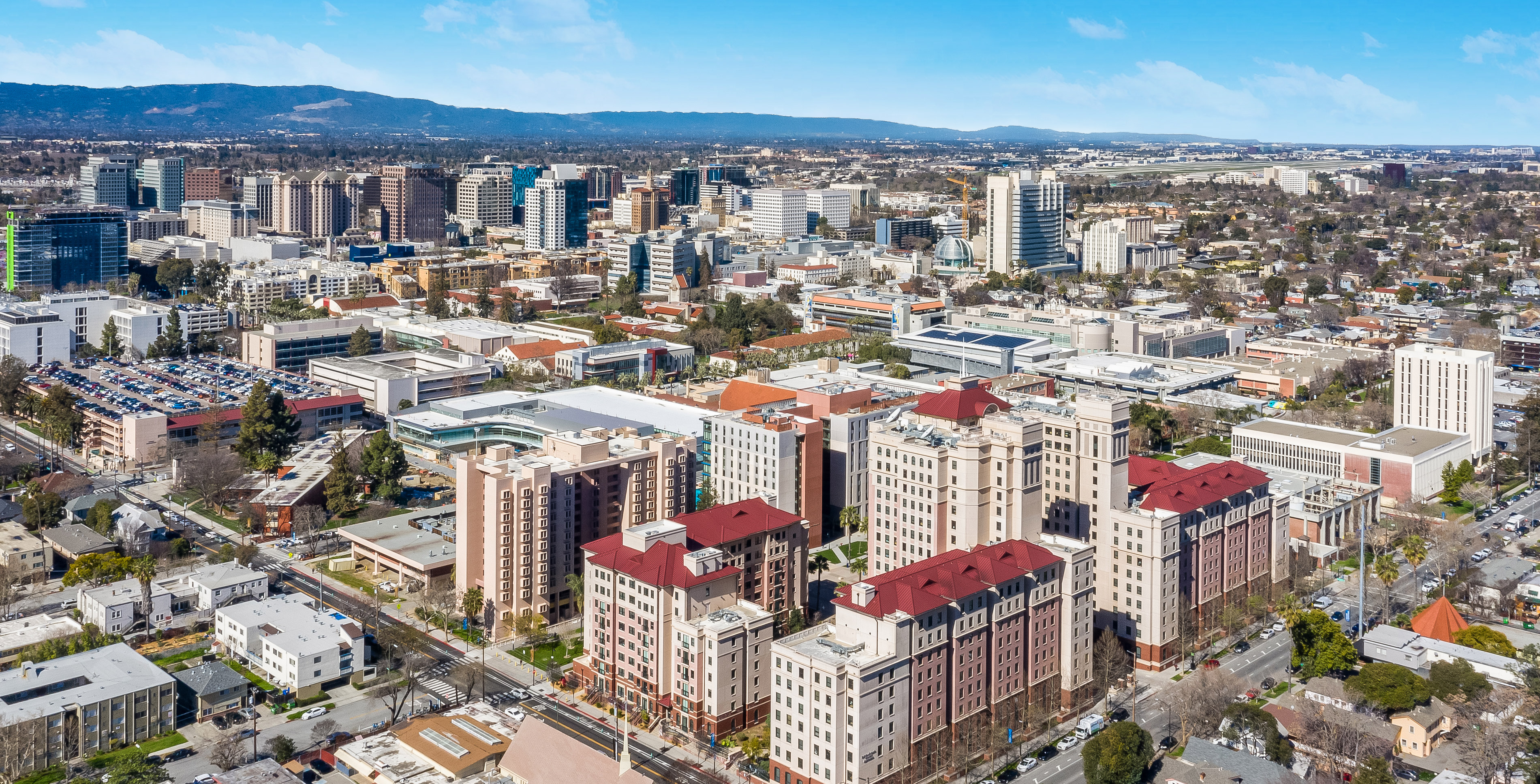 An aerial view of campus, looking northwest towards the dorms and mountains beyond.