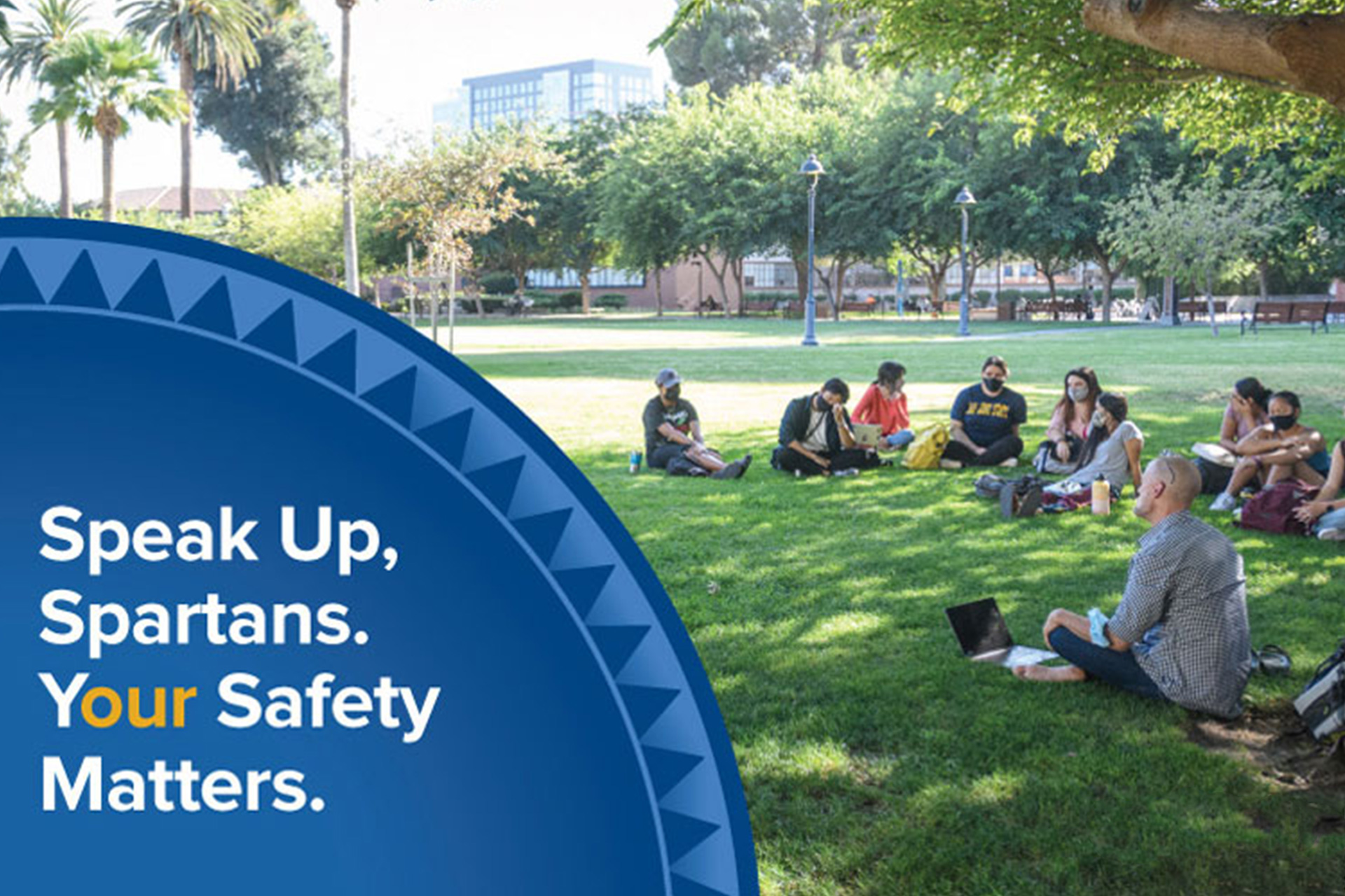 Students sitting in a circle formation on the campus lawn. A shield apprears on the corner with the words Speak Up, Spartans. Your Safety Matters.