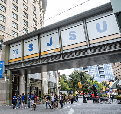 Students touring outside front of the Spartan Village on the Paseo