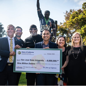 Steve Perez; Charles Ryan; Dr. Harry Edwards; Ash Kalra; Maya Esparza and Cindy Chavez hold a large check.