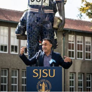 California Assemblymember Ash Kalra speaking at a podium at SJSU.