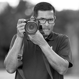 Marcio Sanchez holding a digital camera.