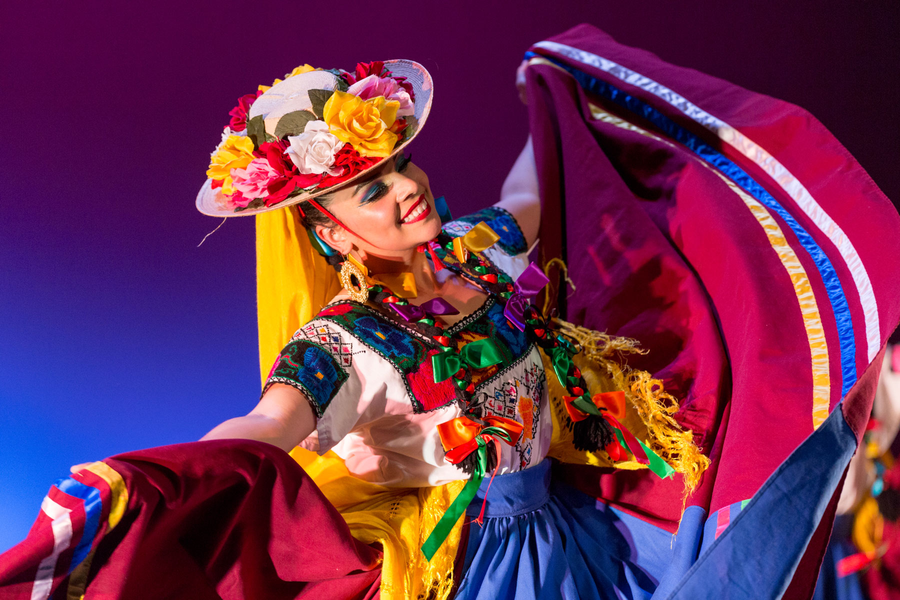 a dancer in colorful regalia.