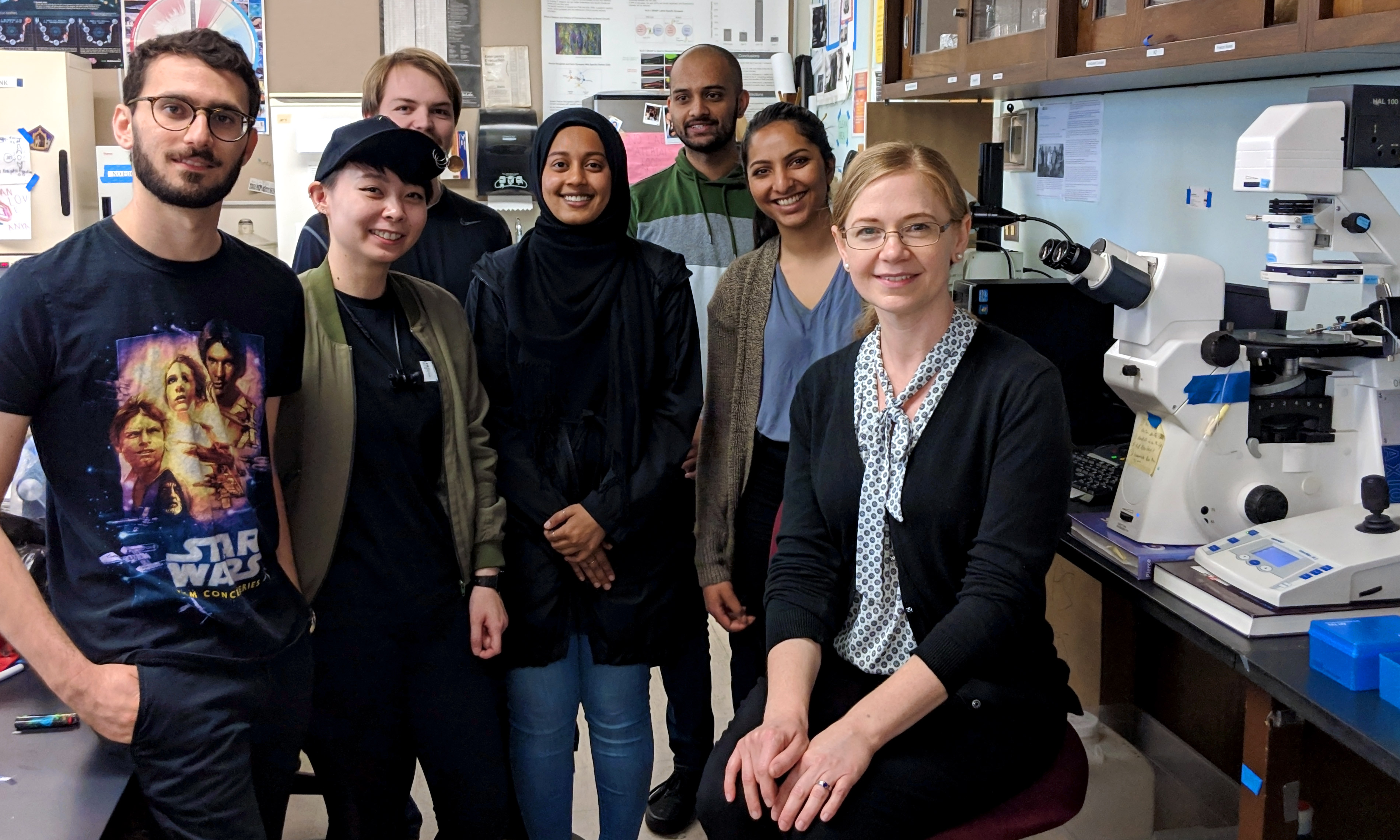 a group of students and their professor in an sjsu biology lab