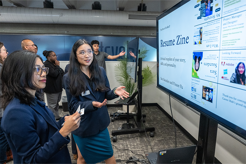 students looking at a presentation at the hub