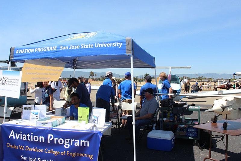 Students under a tent at the Palo Alto Airport Open House