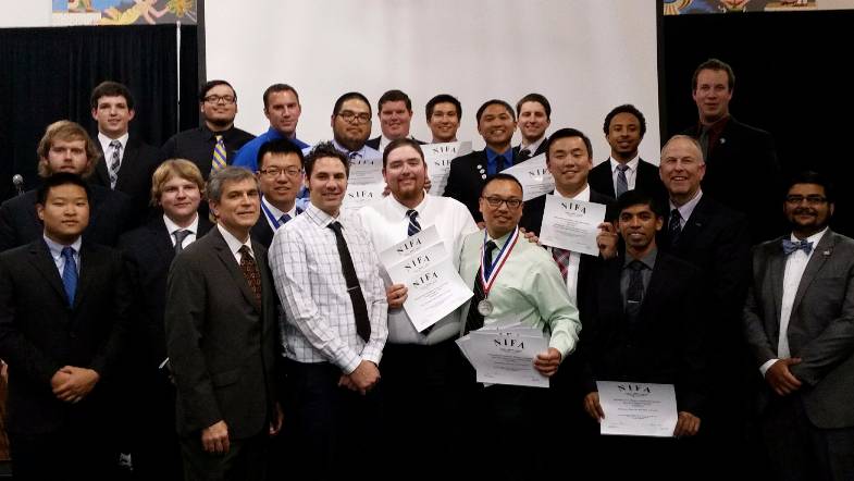 Large group of students and faculty pose for picture at the banquet awards.