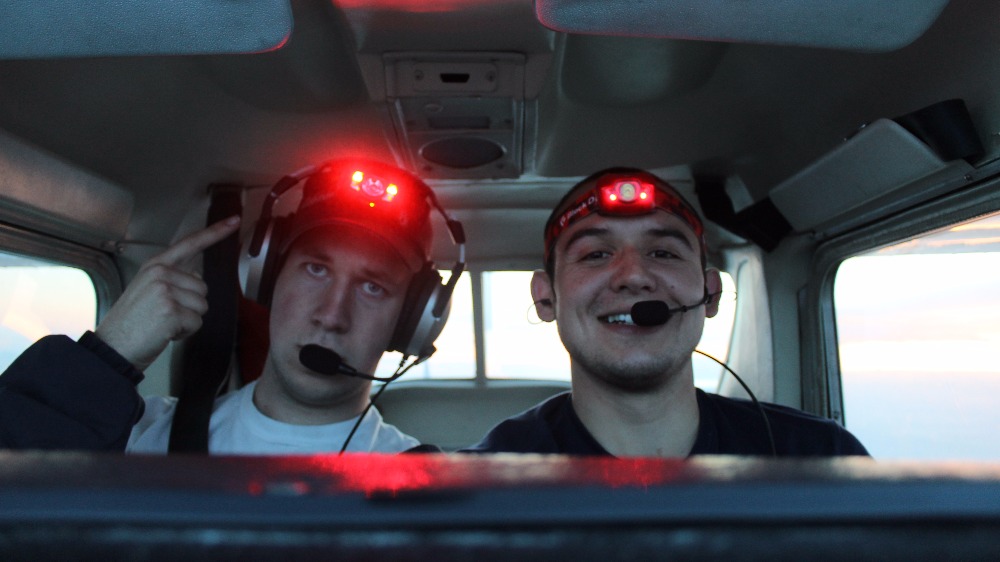 Two students in the cockpit of a plane.