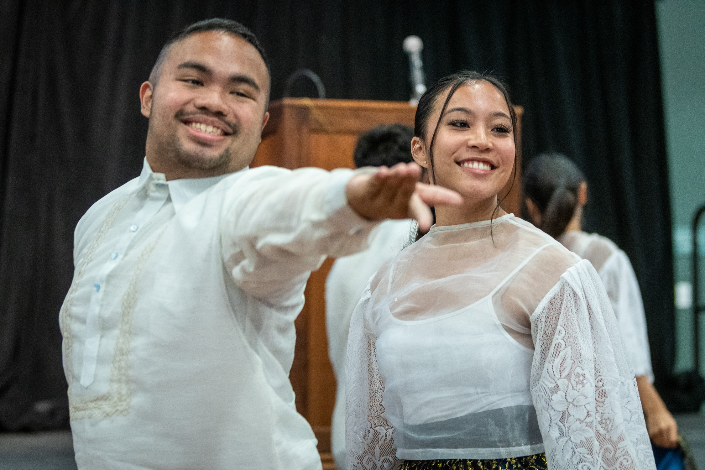 Two students performing a Filipino cultural dance.
