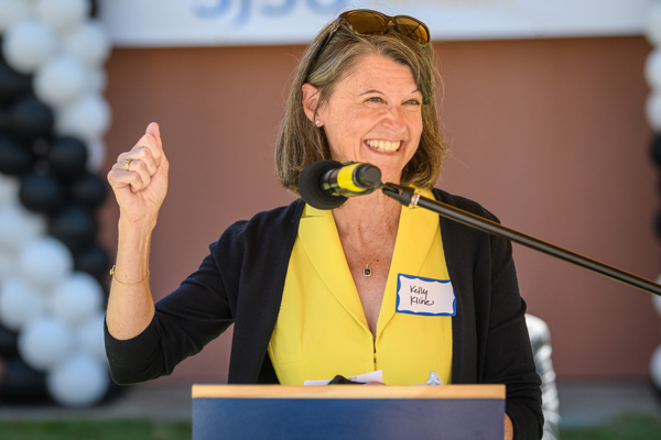 a woman smiling with microphone