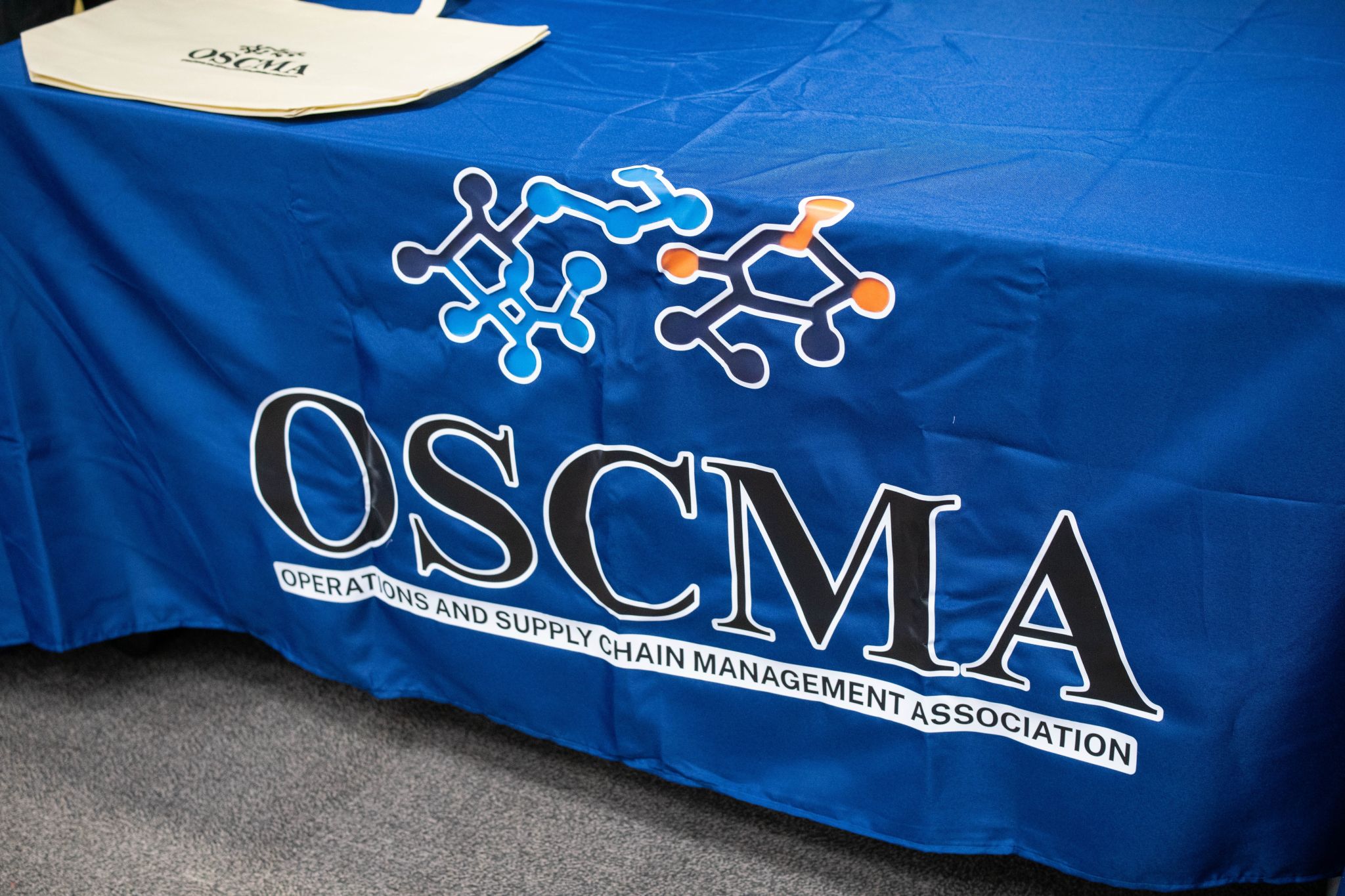 Blue table cloth with OSCMA printed on it