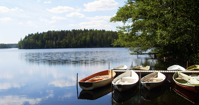 A picture of a lake in Jyvaskyla, Finland with boats docked at a pier.