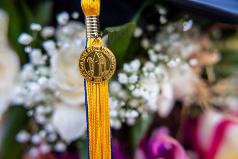 SJSU Blue & gold tassel with tower charm imaged with floral backdrop