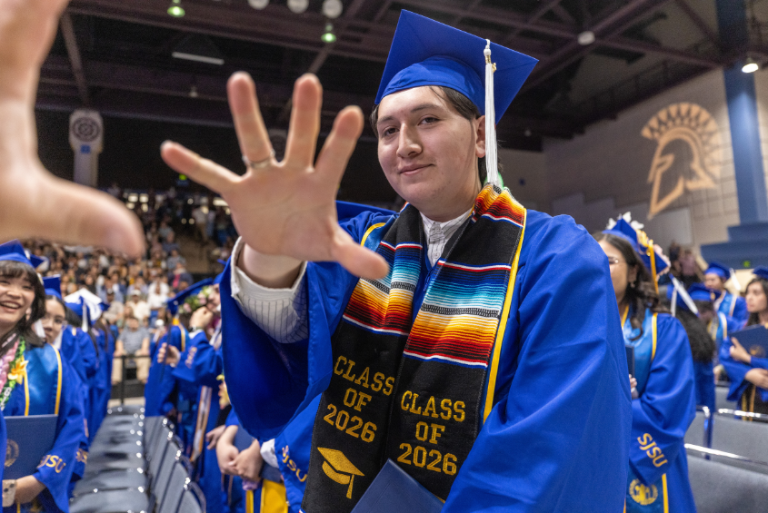 Student reaching out their hand to the camera