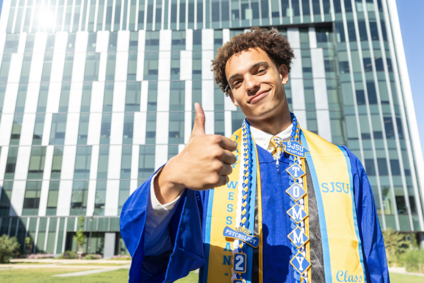 Student holding up a thumbs up