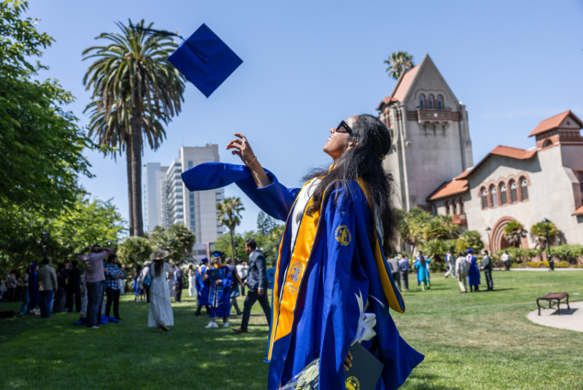 Student throwing their cap in the air