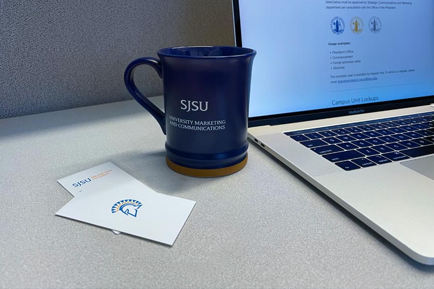 Branded mug and business cards with sjsu marks.