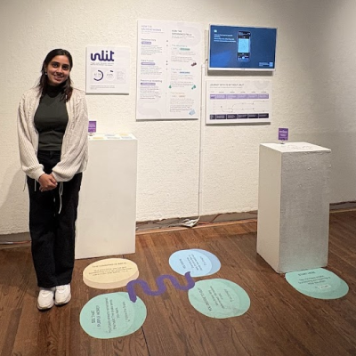Sanika Barawkar posing in front of gallery exhibition