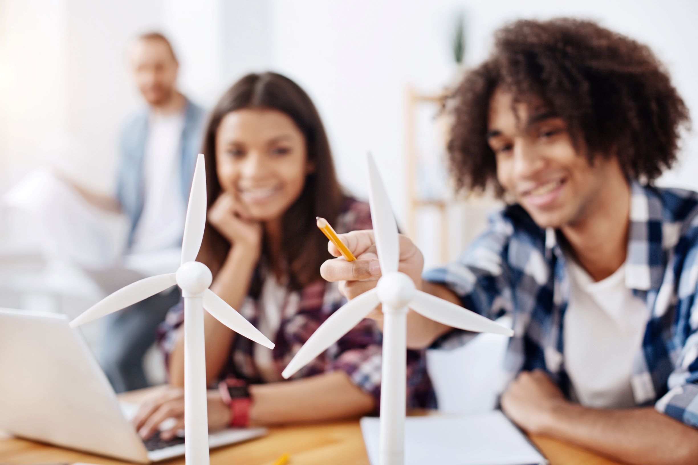 Two students discussing over a wind turbine 