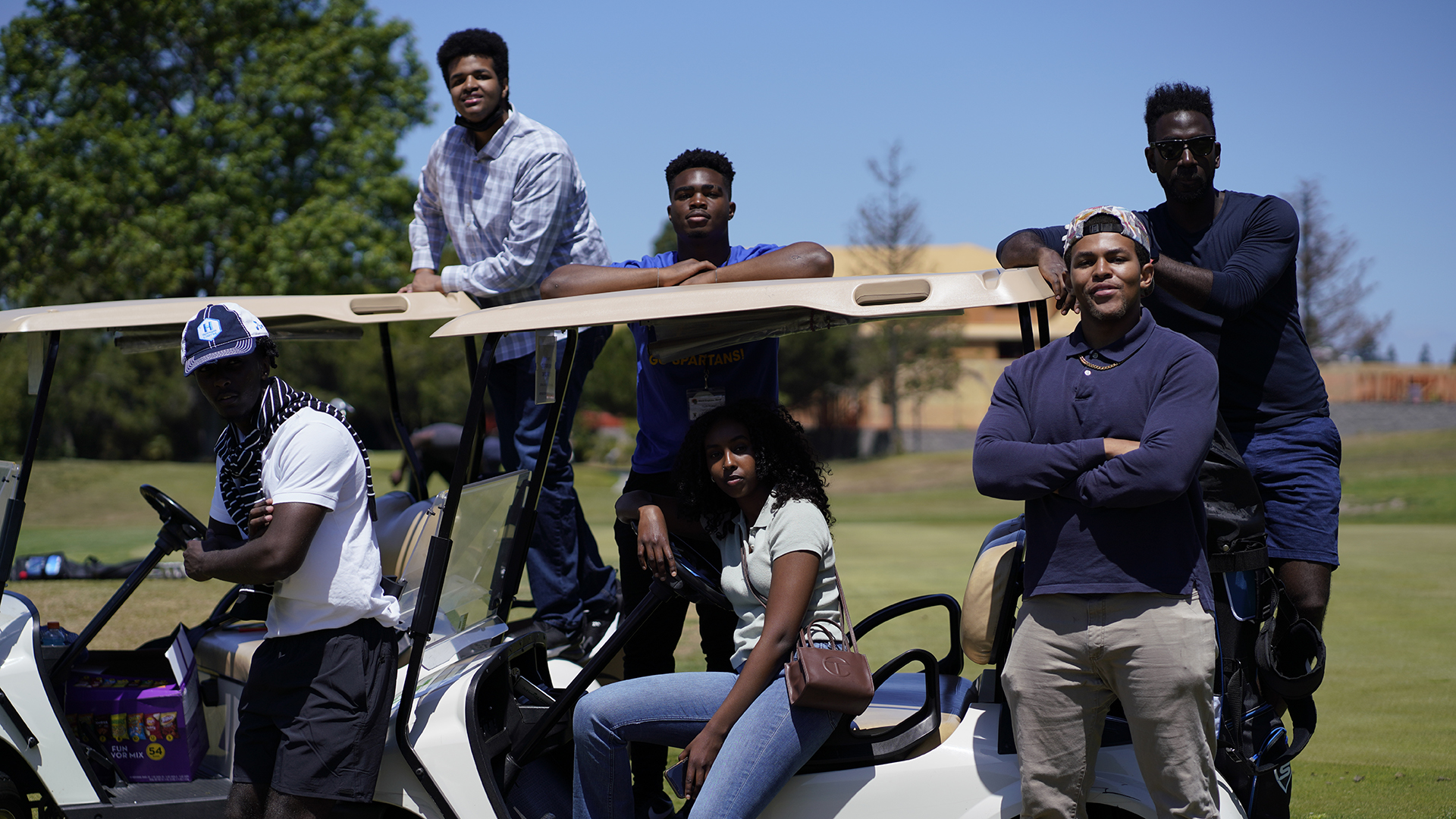 Students riding a golf cart.