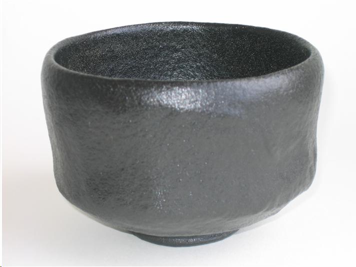 A bowl for thick tea with a soft black glaze. It has an orange-peel texture.  The bowl is slightly irregular and looks as if it would feel good in your hands.