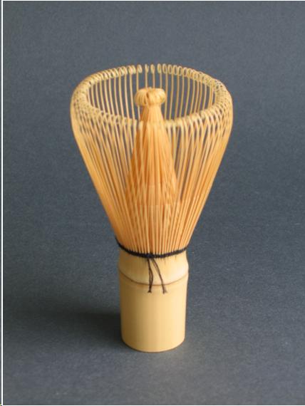 A tea whisk called a "chasen" in Japanese. It is made from a piece of bamboo about 3/4 of an inch in diameter and about 5 inches tall. The top 60% of the bamboo has been split into 100 small tines. Alternate tines are bent outward and inward. The outward tines form a circle with the tops of the tines bent inward. The inward tines are bent toward the center of the circle and twisted at the top.There is a black string around the area where the tines split off from the bamboo handle. It looks a little like a shaving brush and is used to whip powdered tea to a froth. 