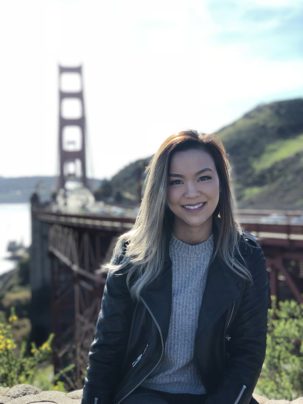 Portrait of Jenny Nguyen with Golden Gate Bridge in the background.