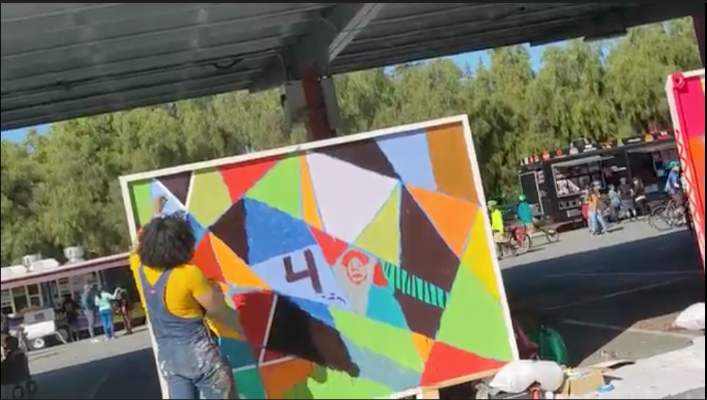 john contreras painting on a mural board