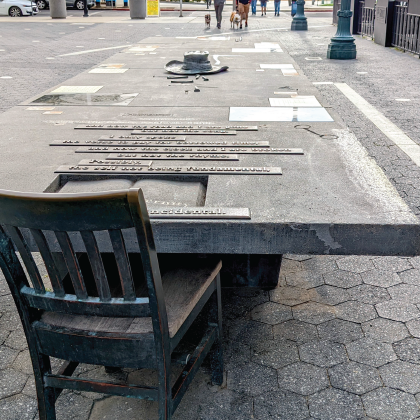 concrete table on paseo with artwork.