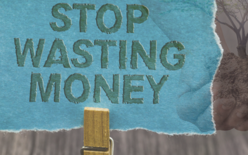 image of a sign saying "stop wasting money"