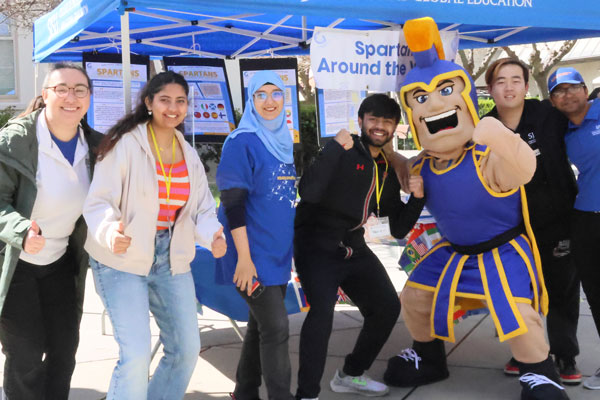 International students posing with Sammy