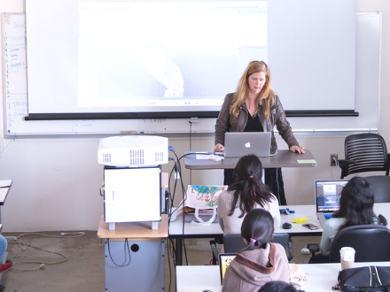 instructor presenting in class using a digital projector.