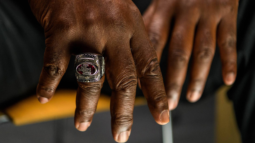 Hands with a 49ers championship ring on it.