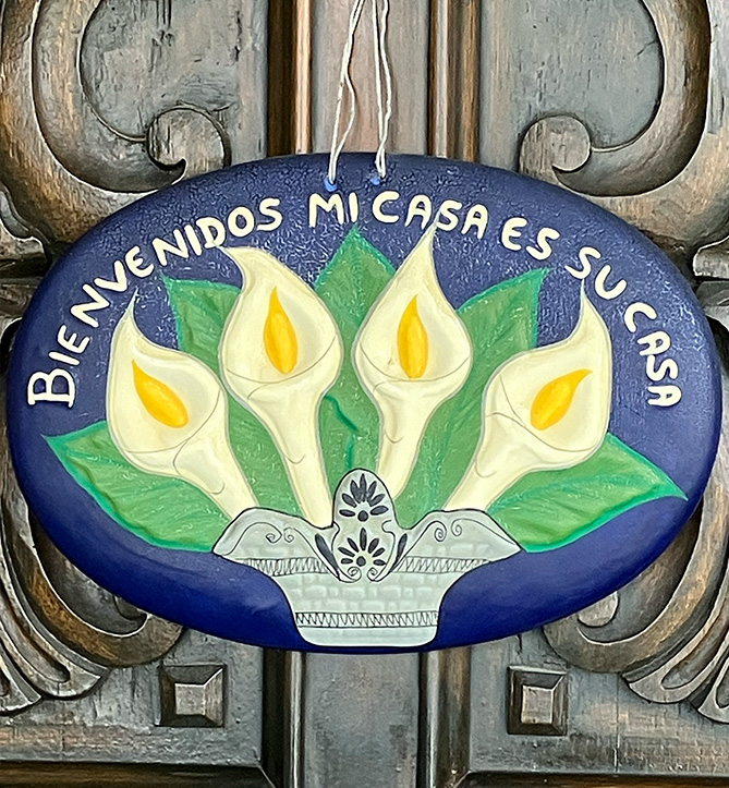 "Bienvenidos Mi Casa es Su Casa" plaque hanging on Charlene Archibeque's door.