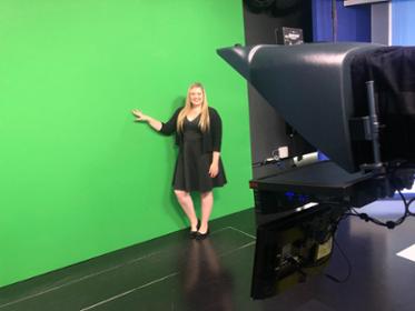 Meteorology Student in front of a NBS green screen.
