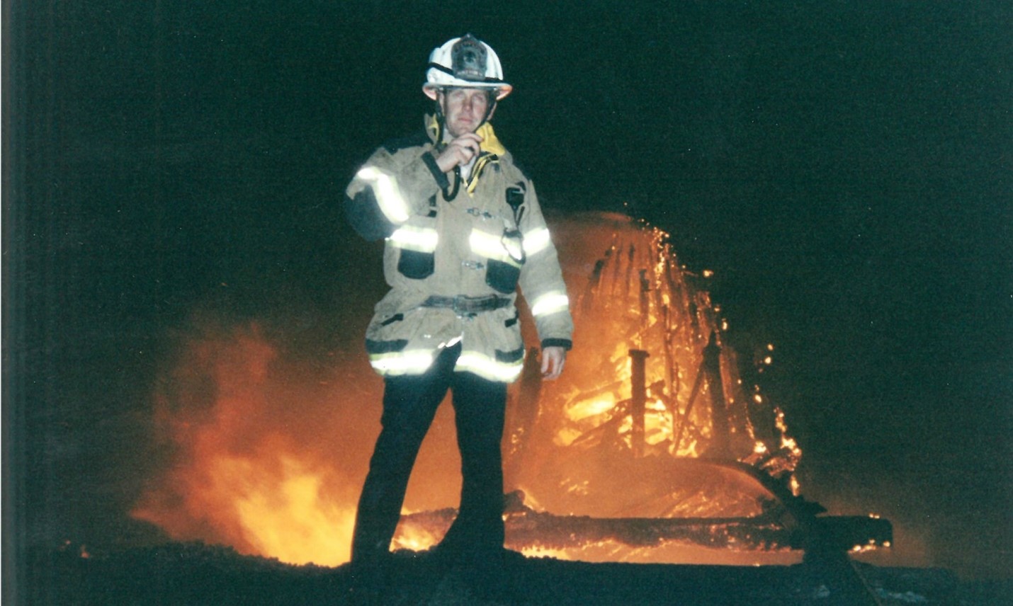 Firefighter stands in front of Dumbarton fire
