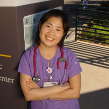 Nursing student in purple scrubs.