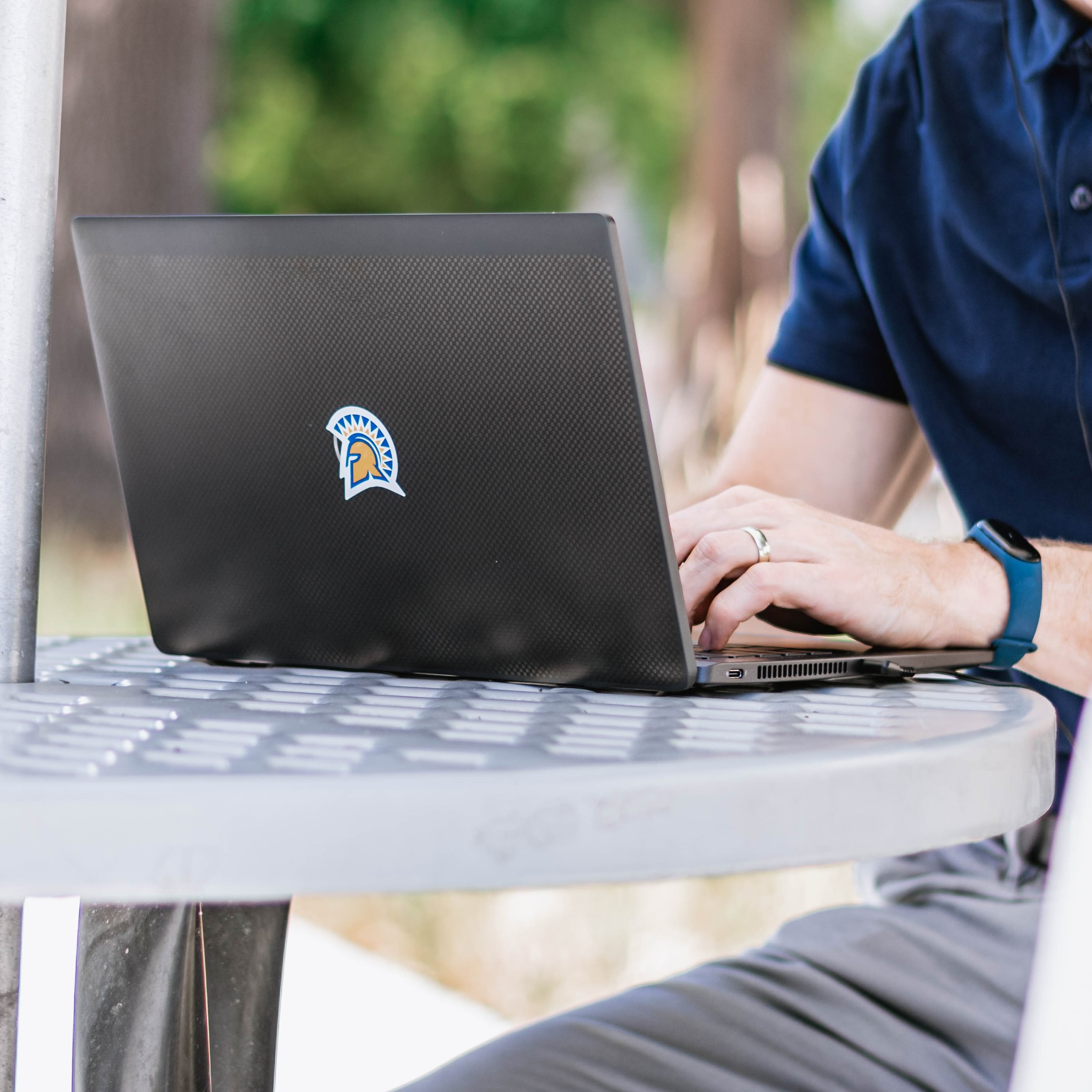 SJSU Online student on laptop