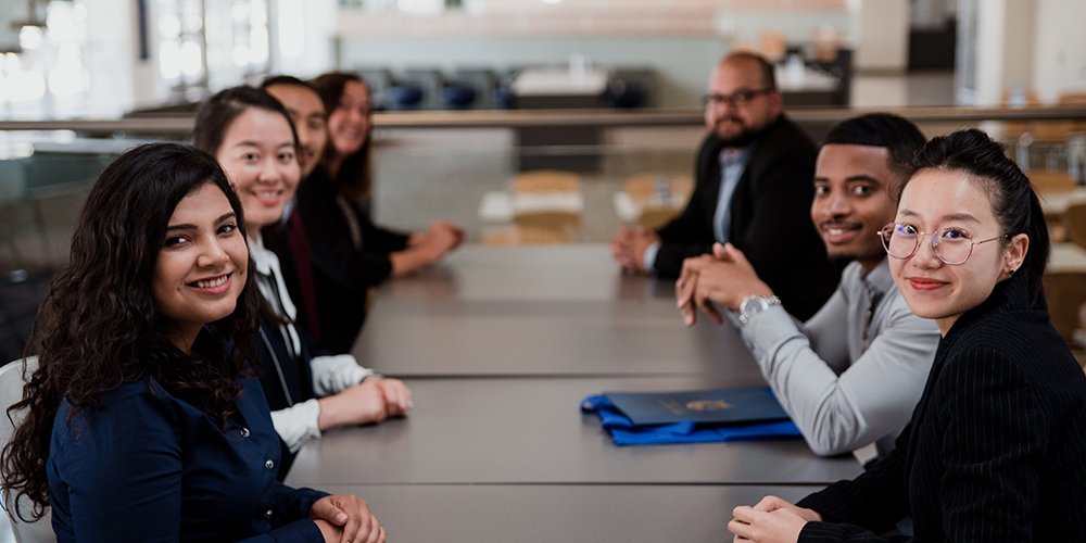 Business students sitting around a conference room table