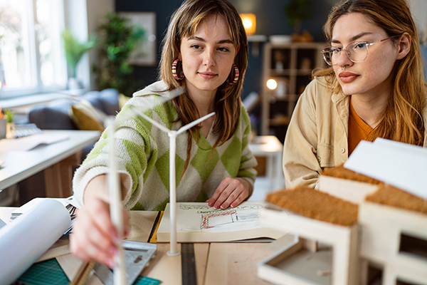 Female students with a wind turbine prototype