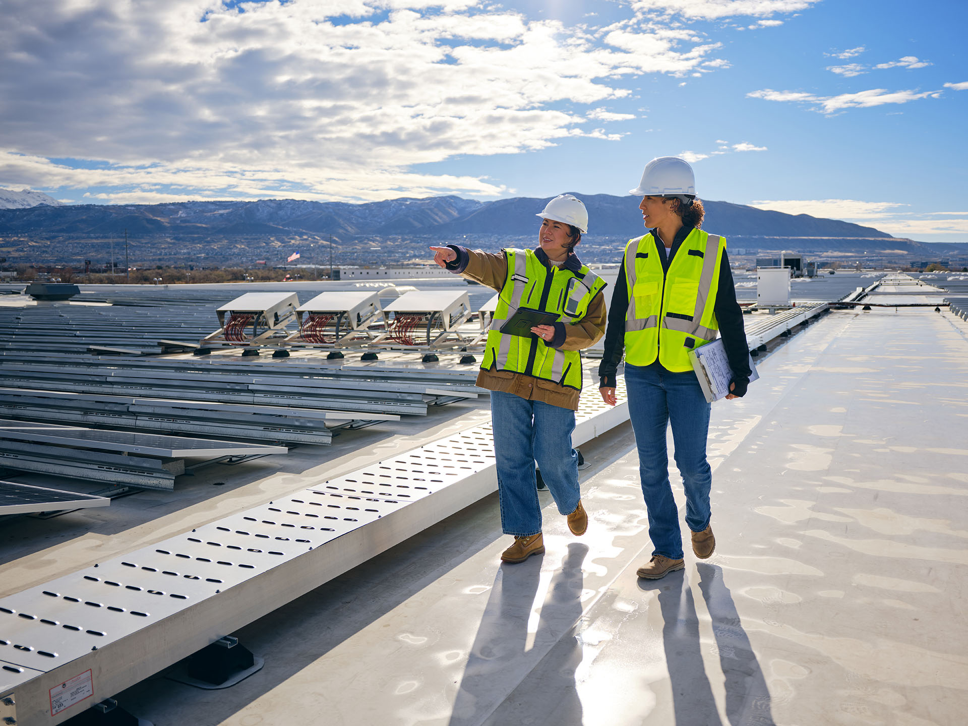 Female engineers inspecting solar panel