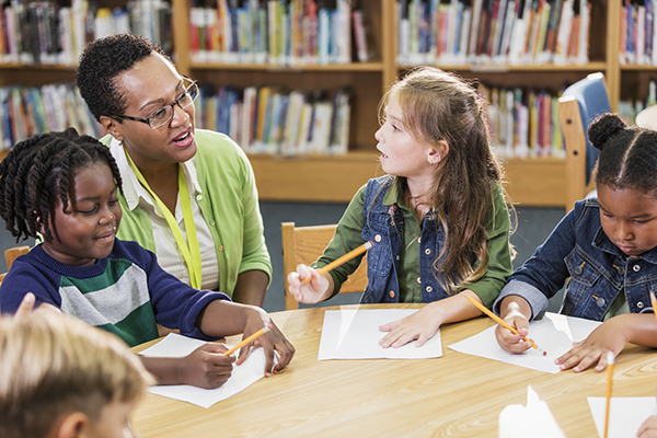 Female librarian with elementary students