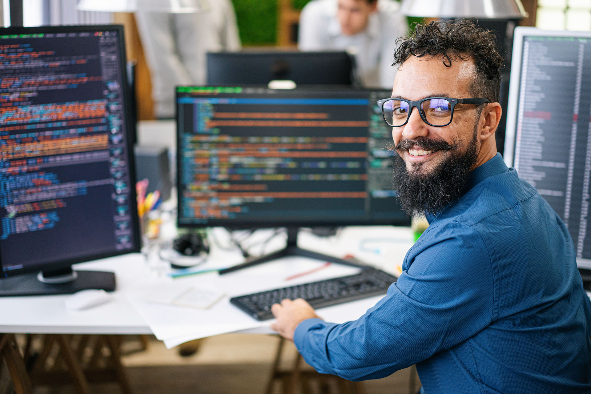 Male data scientist in front of computer monitor