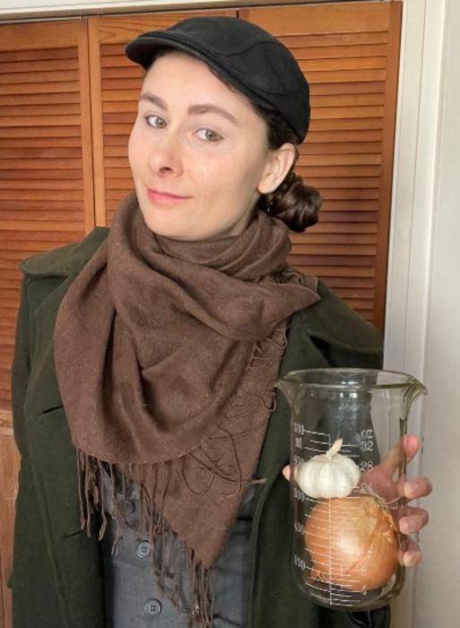 Researcher Cassandra Boyd holding garlic and onion, two foods that the study revealed to be dense in prebiotics.