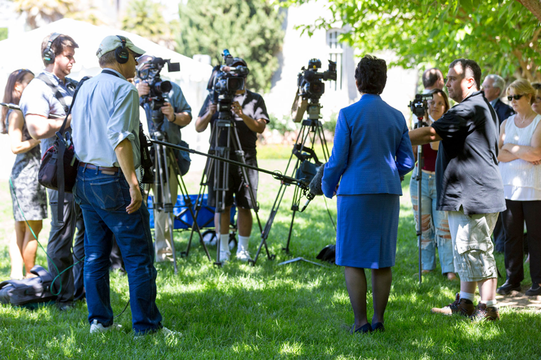 Mary Papazian facing a group of cameras.